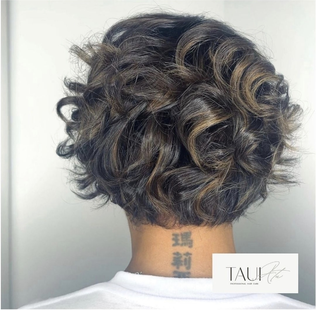 Back view of a curly bob with bronze highlights
